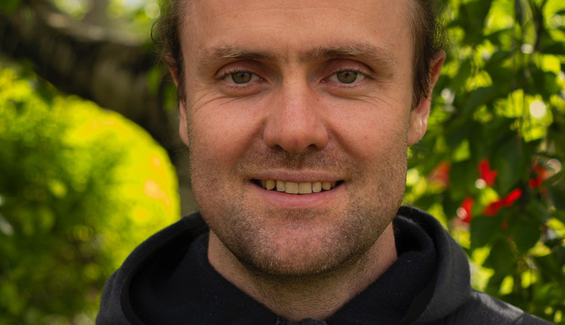 Portrait of Moritz Lang with greenery in the background