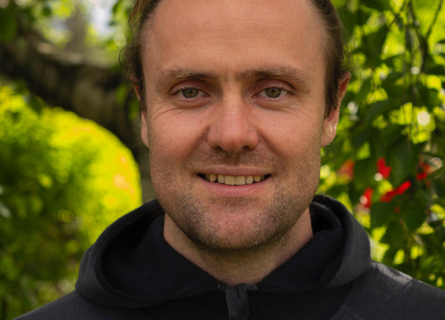 Portrait of Moritz Lang with greenery in the background
