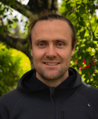 Portrait of Moritz Lang with greenery in the background
