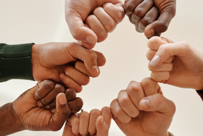 Fists of people with different skin tone